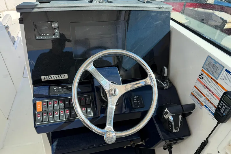  Yacht Photos Pics 2023 Pursuit DC 295 Dual Console boat dashboard with steering wheel and controls.
