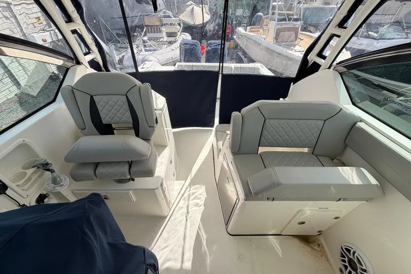  Yacht Photos Pics 2023 Pursuit DC 295 Dual Console interior with gray seating and modern design.