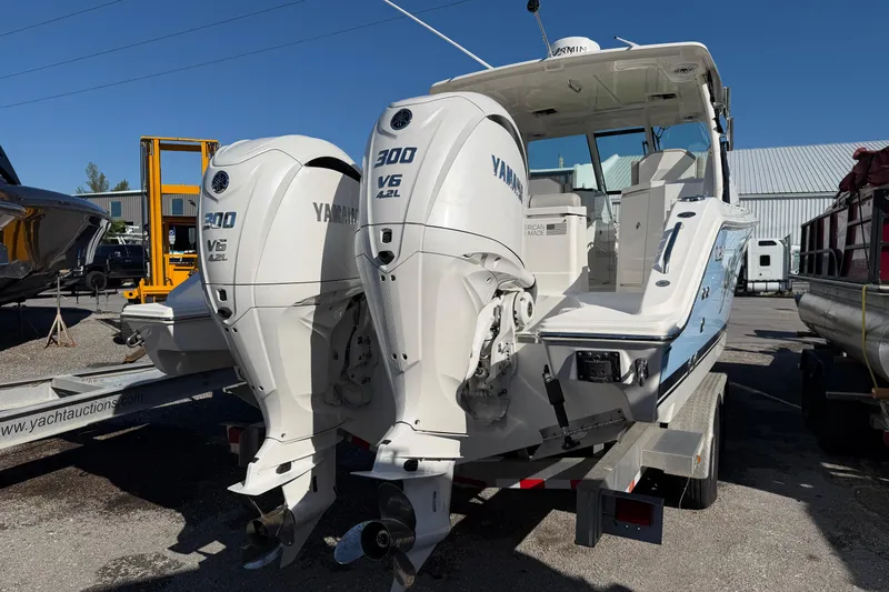  Yacht Photos Pics 2023 Pursuit DC 295 Dual Console boat with twin Yamaha 300 V6 engines on trailer.