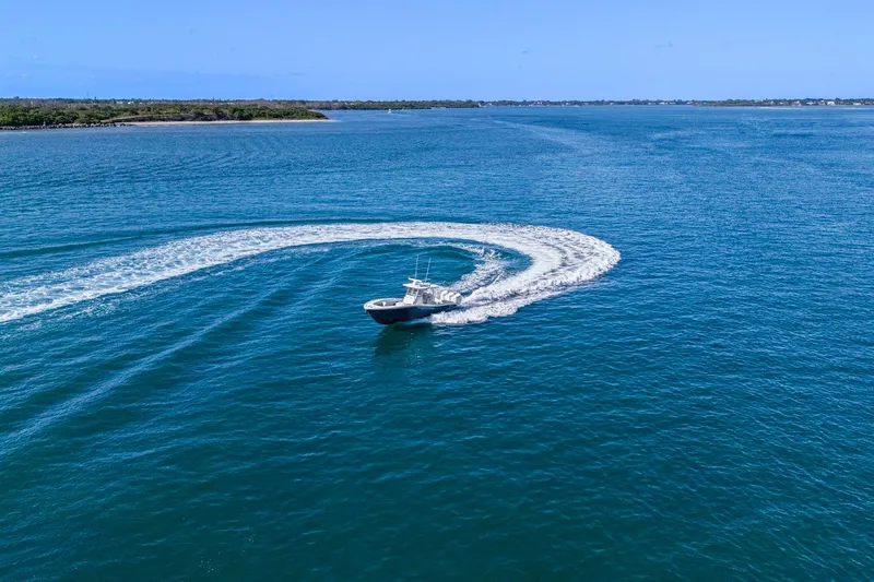 New Stock Yacht Photos Pics 2026 Yellowfin 36 Offshore boat making a sharp turn on open water.