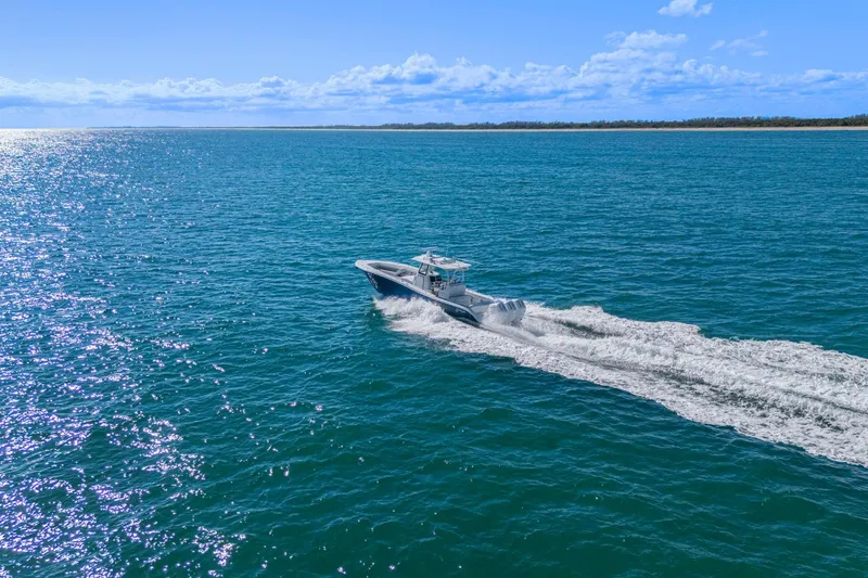New Stock Yacht Photos Pics 2026 Yellowfin 36 Offshore boat cruising on open blue ocean under clear sky.
