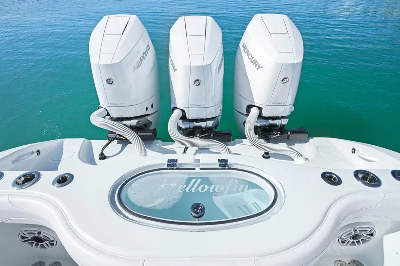 New Stock Yacht Photos Pics 2026 Yellowfin 36 Offshore boat with triple Mercury engines on clear water.