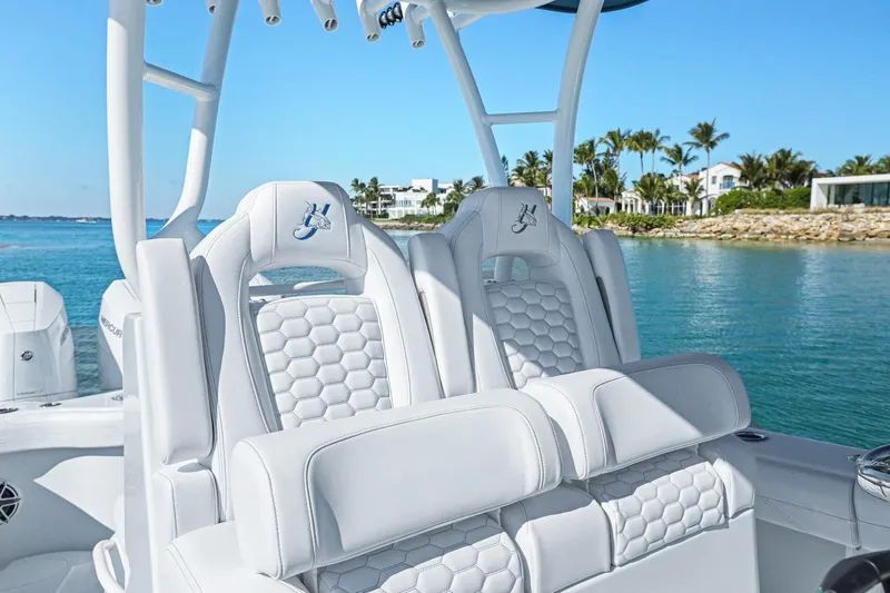 New Stock Yacht Photos Pics 2026 Yellowfin 36 Offshore boat interior with luxurious white seating by the water.
