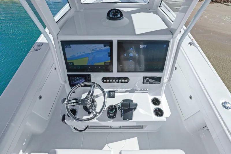 New Stock Yacht Photos Pics 2026 Yellowfin 36 Offshore boat helm with dual screens and modern controls.