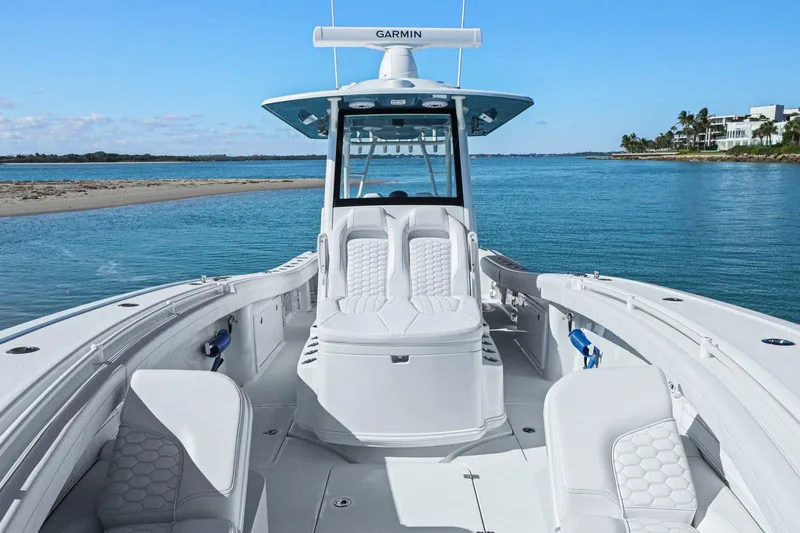 New Stock Yacht Photos Pics 2026 Yellowfin 36 Offshore boat on calm blue water, featuring luxurious seating and Garmin equipment.