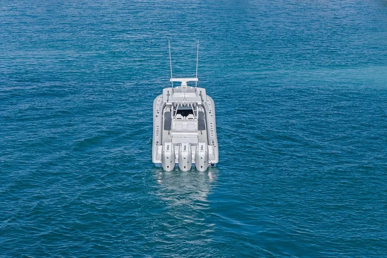 New Stock Yacht Photos Pics 2026 Yellowfin 36 Offshore boat on open blue water, rear view.