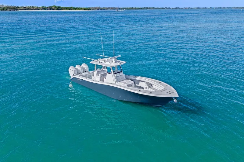 New Stock Yacht Photos Pics 2026 Yellowfin 36 Offshore boat on clear blue water, showcasing sleek design and powerful engines.