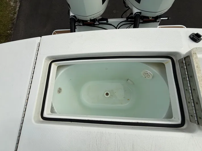 Drillin'n Billin Yacht Photos Pics 2017 Regulator 28 boat with open storage compartment and engines.