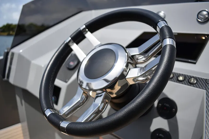  Yacht Photos Pics Steering wheel of 2022 De Antonio Yachts D28 Open, showcasing sleek design and modern controls.
