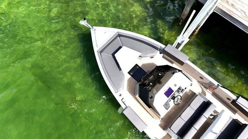  Yacht Photos Pics De Antonio Yachts D28 Open 2022 on clear green water, aerial view.