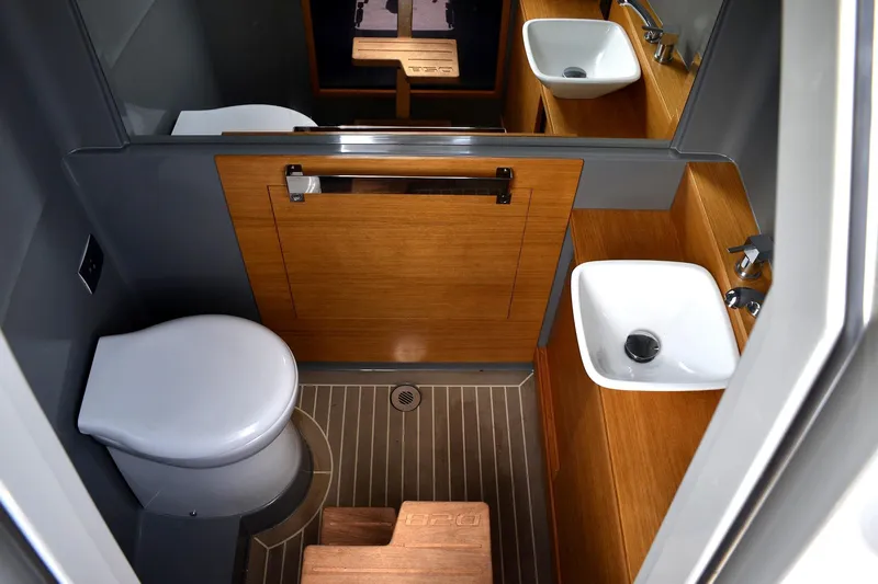  Yacht Photos Pics Bathroom interior of 2022 De Antonio Yachts D28 Open, featuring modern fixtures and wood accents.