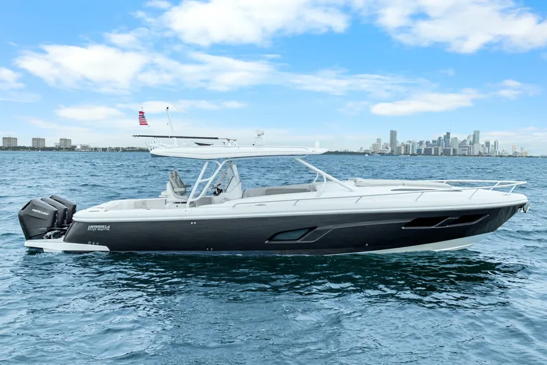  Yacht Photos Pics 2024 Intrepid 41 Valor boat on water with city skyline in background.