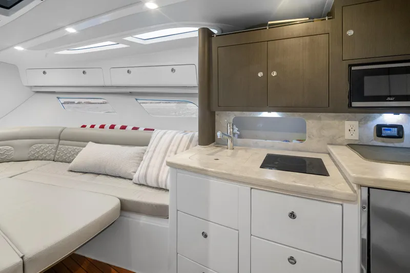  Yacht Photos Pics Luxurious interior of 2024 Intrepid 41 Valor yacht with modern kitchenette and seating area.