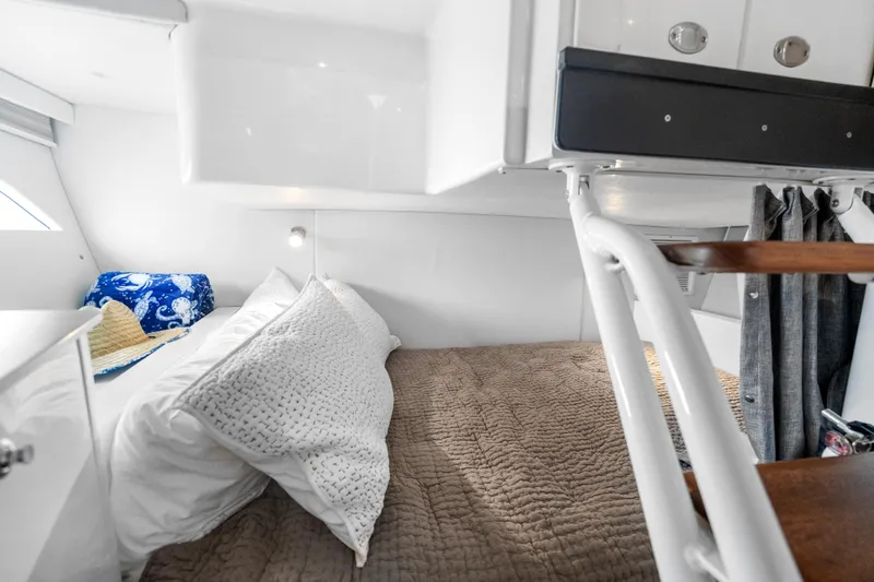  Yacht Photos Pics 2024 Intrepid 41 Valor cabin interior with cozy bedding and modern design.