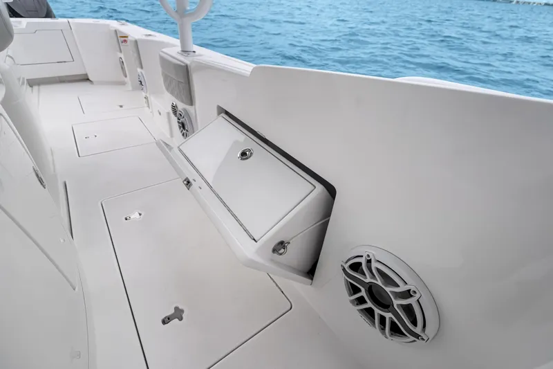  Yacht Photos Pics 2024 Intrepid 41 Valor boat interior with storage compartment and speaker, overlooking the ocean.