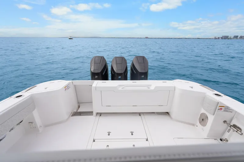  Yacht Photos Pics 2024 Intrepid 41 Valor boat with triple outboard engines on open sea.