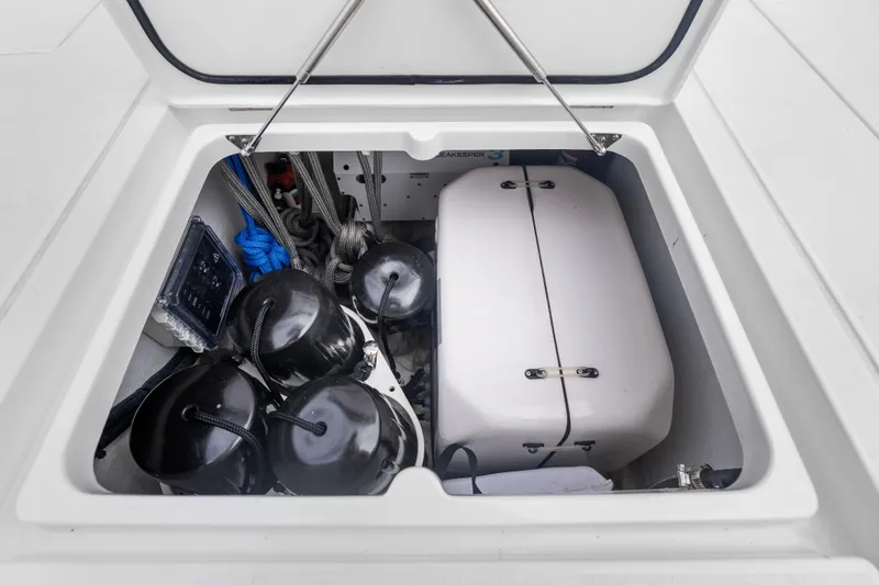  Yacht Photos Pics Open storage compartment on 2024 Intrepid 41 Valor boat, featuring ropes and fenders.