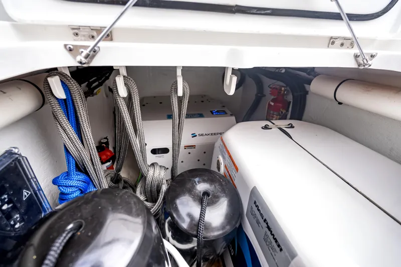  Yacht Photos Pics Storage compartment of 2024 Intrepid 41 Valor boat with ropes, equipment, and fire extinguisher.