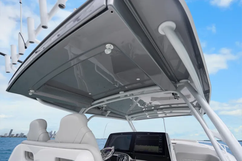  Yacht Photos Pics 2024 Intrepid 41 Valor boat helm with modern dashboard and seating, under a sleek canopy.