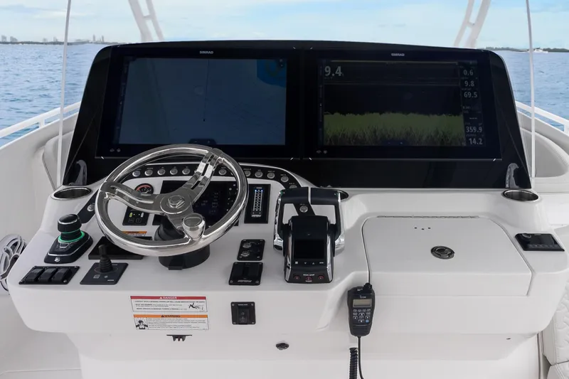  Yacht Photos Pics 2024 Intrepid 41 Valor helm with advanced navigation displays and controls on open water.