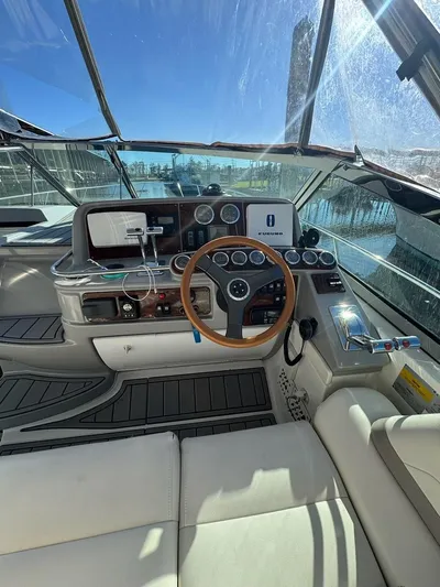 Cash Is King Yacht Photos Pics 2002 Formula 40 PC yacht cockpit with steering wheel and navigation instruments.