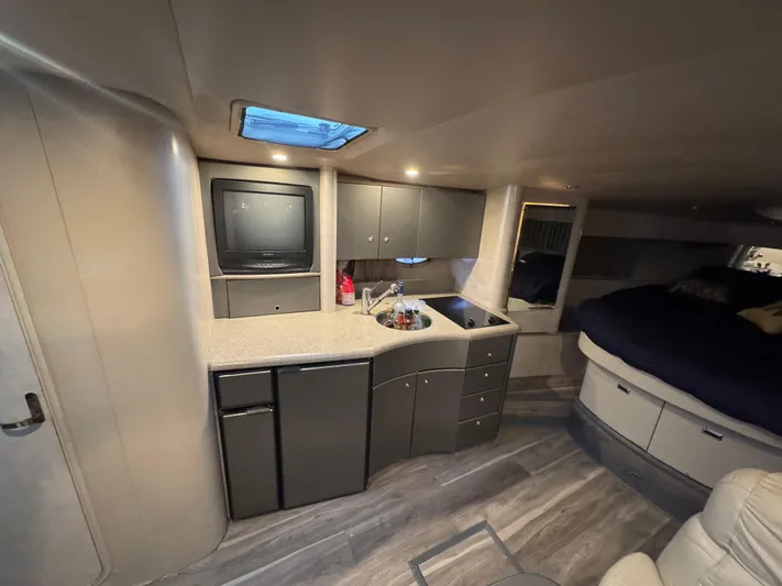 Cash Is King Yacht Photos Pics Interior of 2002 Formula 40 PC yacht with kitchenette, TV, and sleeping area.