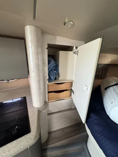 Cash Is King Yacht Photos Pics Interior of a 2002 Formula 40 PC boat showing open cabinet and bed area.