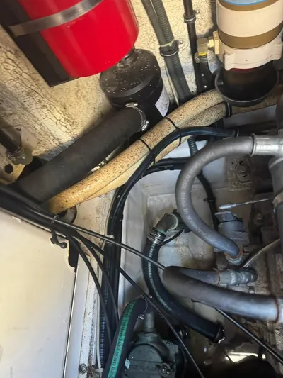 Cash Is King Yacht Photos Pics Engine compartment of a 2002 Formula 40 PC boat, showing hoses and mechanical components.