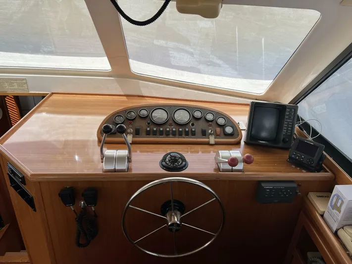 Yacht Z Yacht Photos Pics Cockpit of 1998 Riviera 48 Convertible yacht with steering wheel and navigation instruments.