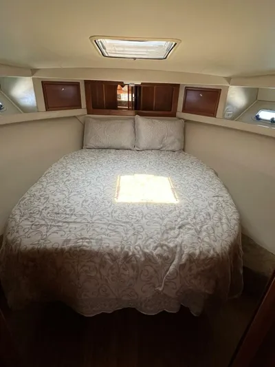Yacht Z Yacht Photos Pics Cozy bedroom in 1998 Riviera 48 Convertible yacht with elegant bedding and natural light.