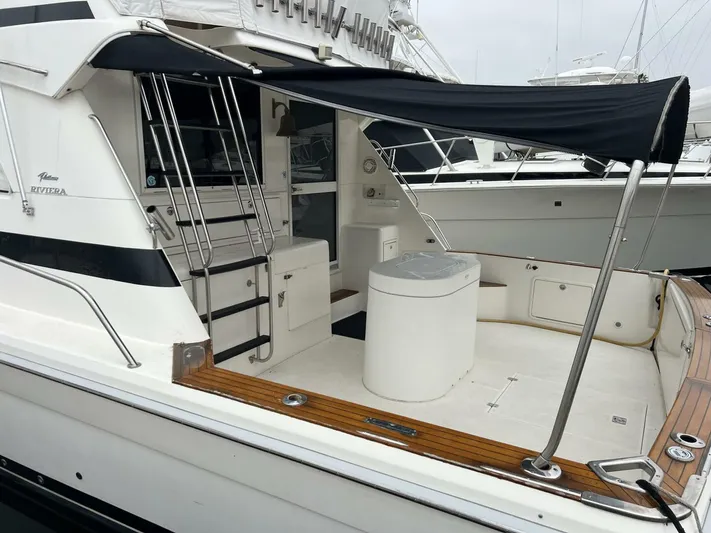 Yacht Z Yacht Photos Pics 1998 Riviera 48 Convertible yacht with shaded deck and sleek design.