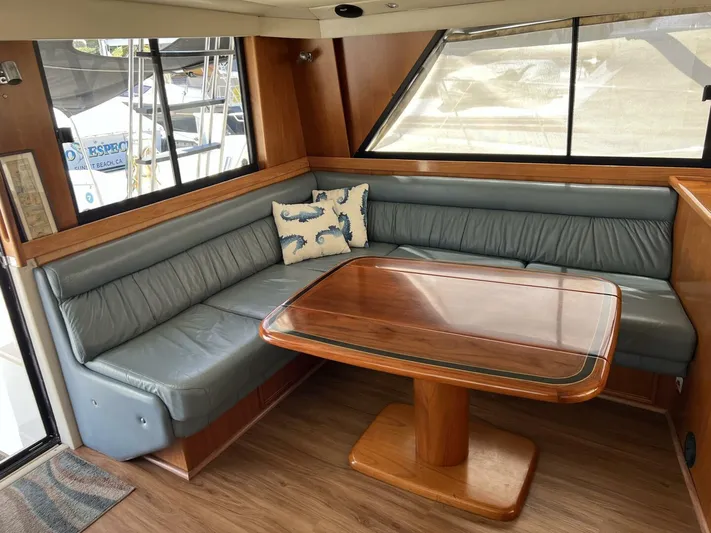Yacht Z Yacht Photos Pics Interior of 1998 Riviera 48 Convertible yacht with leather seating and wooden table.