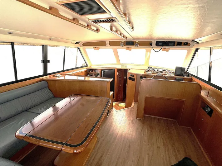 Yacht Z Yacht Photos Pics Interior of 1998 Riviera 48 Convertible yacht with wood finish and seating area.