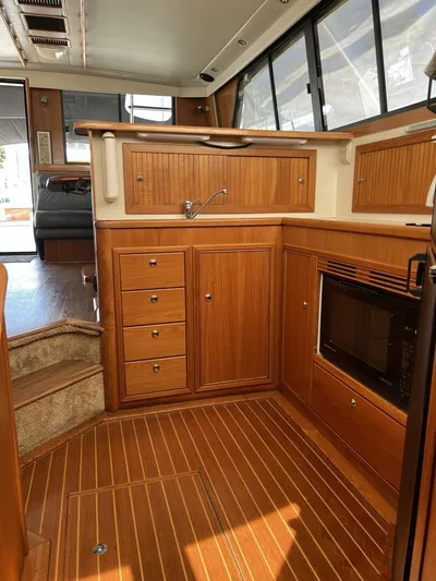 Yacht Z Yacht Photos Pics Luxurious wooden interior of a 1998 Riviera 48 Convertible yacht kitchen.
