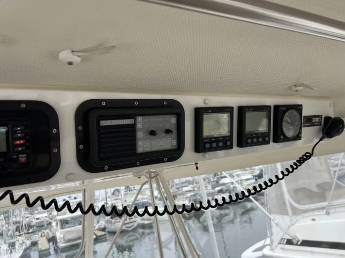 Yacht Z Yacht Photos Pics 1998 Riviera 48 Convertible yacht dashboard with navigation instruments and radio equipment.