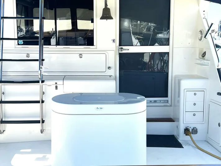 Yacht Z Yacht Photos Pics 1998 Riviera 48 Convertible yacht deck with ladder, storage, and door.