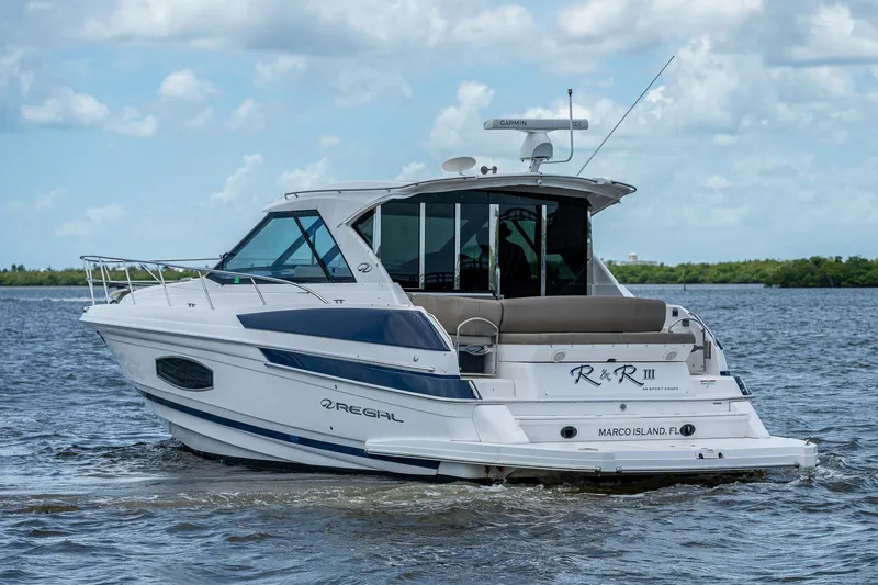 R&r III Yacht Photos Pics 2015 Regal 46 Sport Coupe yacht cruising on a calm lake.
