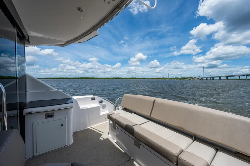 R&r III Yacht Photos Pics 2015 Regal 46 Sport Coupe boat with spacious deck and scenic water view.