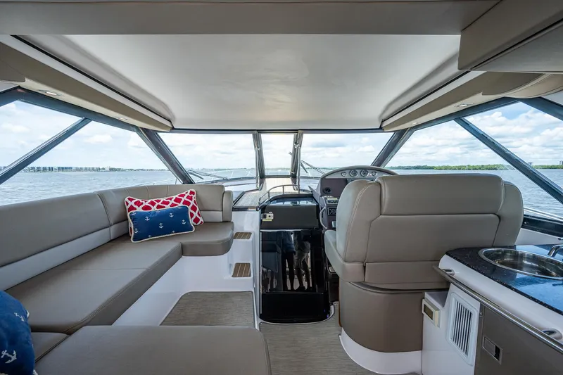 R&r III Yacht Photos Pics Interior of 2015 Regal 46 Sport Coupe yacht with plush seating and panoramic windows.