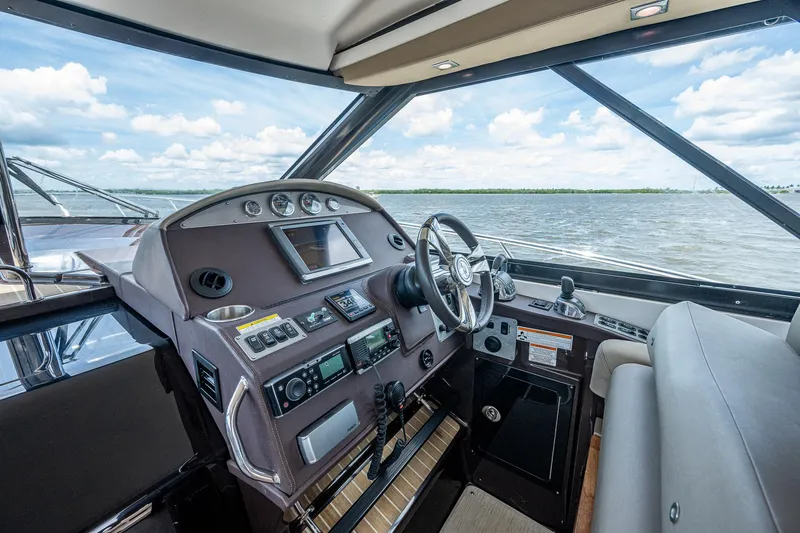 R&r III Yacht Photos Pics Interior helm of 2015 Regal 46 Sport Coupe yacht with modern controls.
