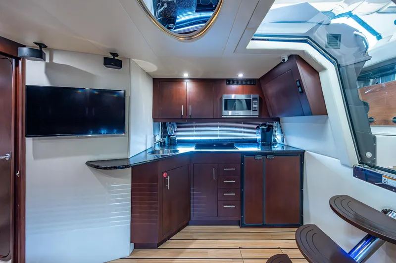 R&r III Yacht Photos Pics Luxurious interior of 2015 Regal 46 Sport Coupe with modern kitchen amenities.