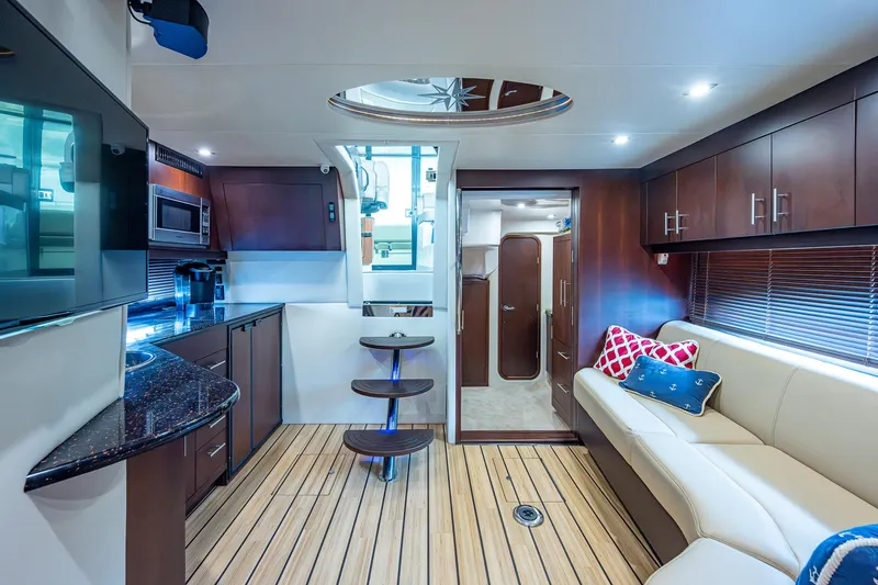 R&r III Yacht Photos Pics Luxurious interior of 2015 Regal 46 Sport Coupe with modern kitchen and cozy seating area.