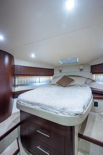 R&r III Yacht Photos Pics Luxurious bedroom in 2015 Regal 46 Sport Coupe yacht with modern lighting and wooden cabinetry.