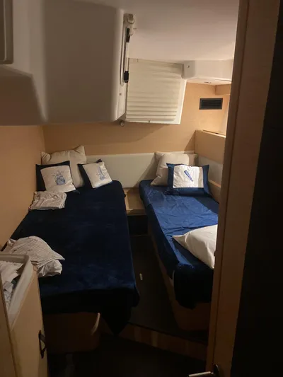 Padraigin II Yacht Photos Pics Interior cabin of 2016 Jeanneau 58 yacht with twin beds and nautical-themed decor.