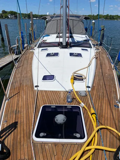 Padraigin II Yacht Photos Pics 2016 Jeanneau 58 sailboat with teak deck, docked at a marina.