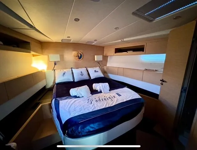 Padraigin II Yacht Photos Pics Luxurious bedroom interior of 2016 Jeanneau 58 yacht with elegant bedding and ambient lighting.