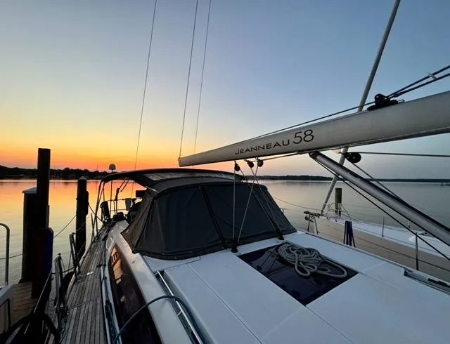 Padraigin II Yacht Photos Pics 2016 Jeanneau 58 yacht docked at sunset, showcasing sleek design and tranquil waters.