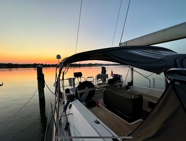 Padraigin II Yacht Photos Pics 2016 Jeanneau 58 sailboat at sunset, docked on calm water.