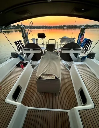 Padraigin II Yacht Photos Pics 2016 Jeanneau 58 yacht deck at sunset, featuring elegant seating and steering wheels.