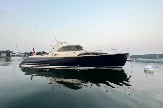 Mamma Mia Yacht Photos Pics 2006 Mochi Craft 51 Dolphin yacht on calm water at sunset.